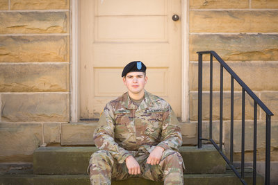 senior guy sitting on steps in army uniform photographed by Jamie Lynette Photography Canton Ohio Senior Photographer
