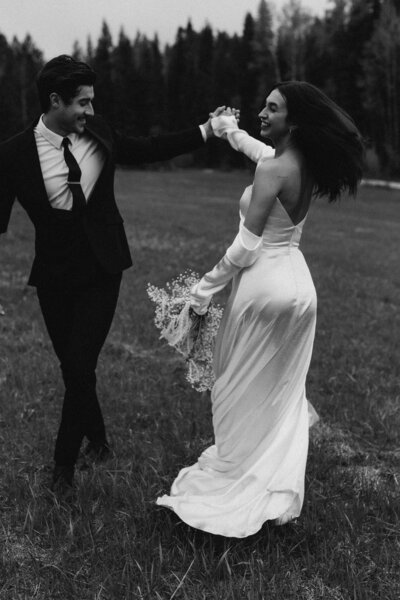 Bride and Groom dancing in the fields in Canada