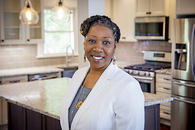 black woman realtor in kitchen branding photo