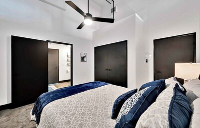 Master bedroom with Queen sized bed in this one-bedroom, one-bathroom luxury rental condo in the historic Behrens building in downtown Waco within walking distance to the Silos, Baylor, and local museums.