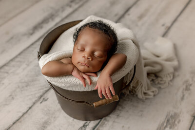 Newborn baby boy posed in a bucket in Charleston, South Carolina.