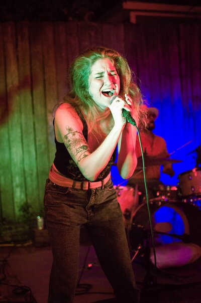 Allison belting into the mic at Moontower Inn in Houston, Texas.