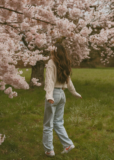 girl standing across Pittock Mansion in Portland, Oregon for senior photos