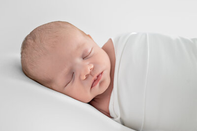 newborn baby sleeping for his  photoshoot in Huntsville Alabama