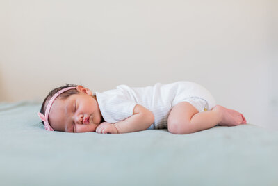 Newborn baby portrait laying on bed