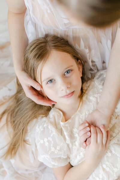 close up image of little girl with blue eyes in omaha family photographer's natural light studio