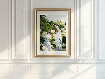 three family photos hanging over green velvet couch in huntsville alabama home