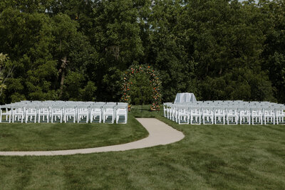 Outdoor ceremony area with floral arch