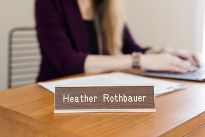 Metal name place with the words "Heather- Rothbauer"