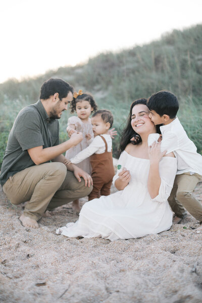 Family Portrait taken at Guana Beach near Jacksonville with the family playing and hugging one another