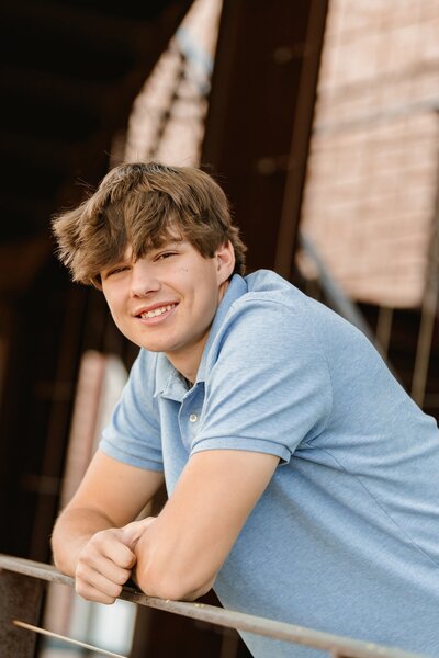 senior boy smiling at the camera at DC Ranch Market street