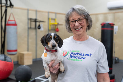 Lori and her dog, Blue, in the Warriors Gym, a Parkinson's gym in Eugene, OR.