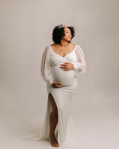 beautiful pregnant woman wearing tight white dress in portland studio session in oregon