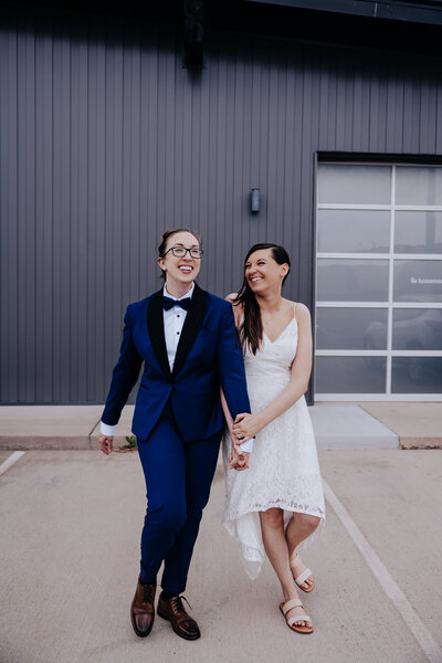 Destination Elopement Photographer captures brides holding hands after mountain wedding