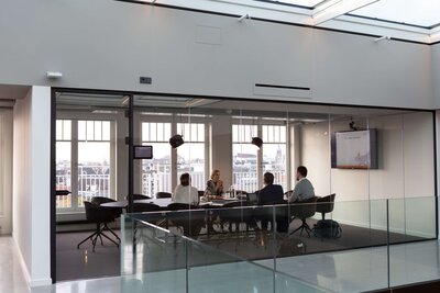 people sitting in conference room in corporate building