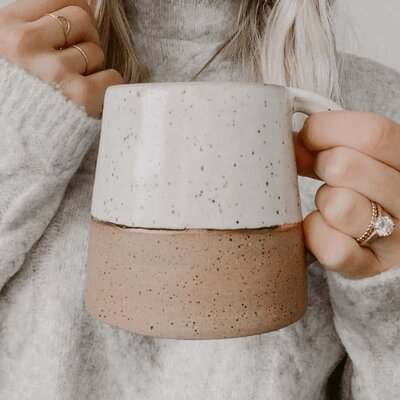 Lady holding a mug with ring on finger