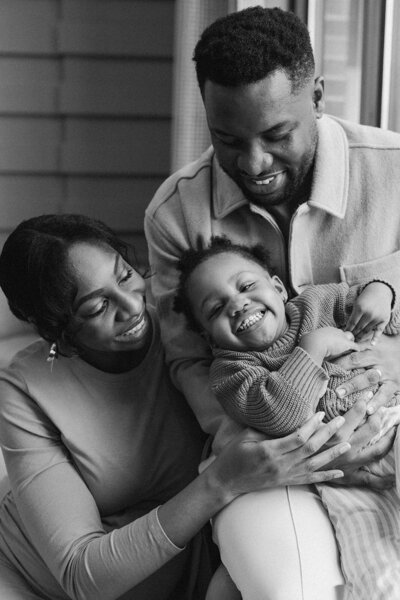 black and white photo of couple with newborn baby atlanta