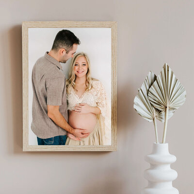 wood framed photo of pregnant couple during Branson MO maternity photography session
