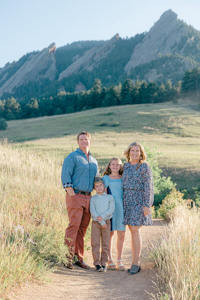 Family of four portrait at Chautauqua Park in Boulder CO. Color palette light blue and brown for their outfits.