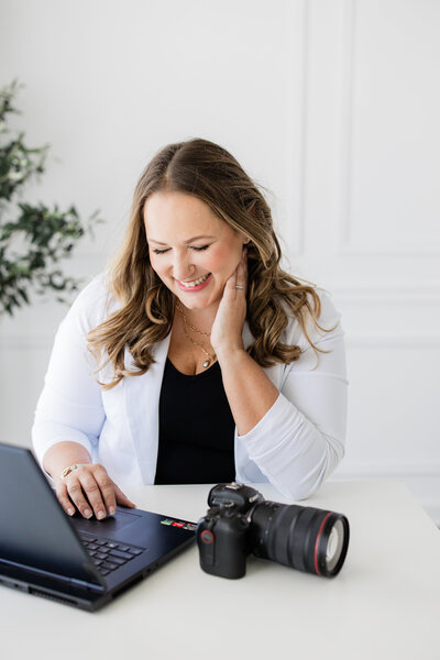 Female entrepreneur working on laptop.