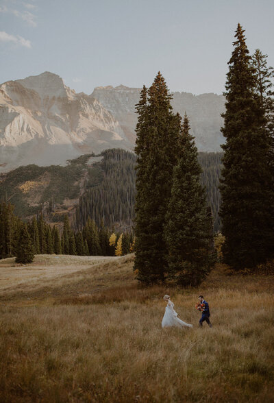 Bride and groom walk together in the Telluride