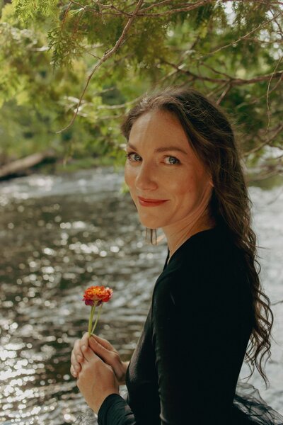 elizabeth in black dress holding flower