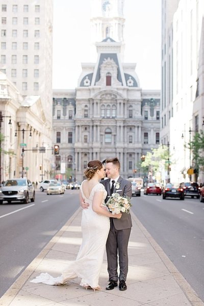 bridesmaids and bride posing in front  of Philadelphia City Hall