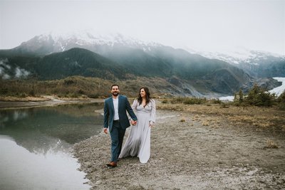 Couple walking away from mendenhall glacier laughing and smiling at each other