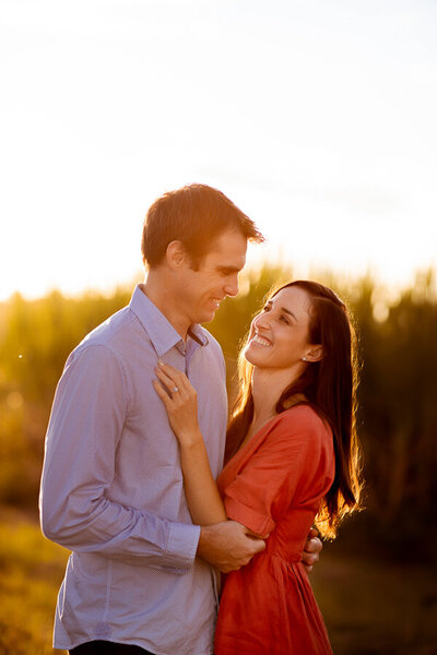 Woman's hand on man's chest while they look at each other