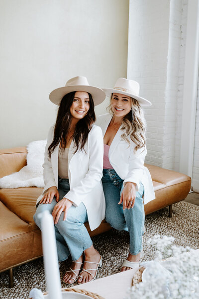 two sisters smiling in hats