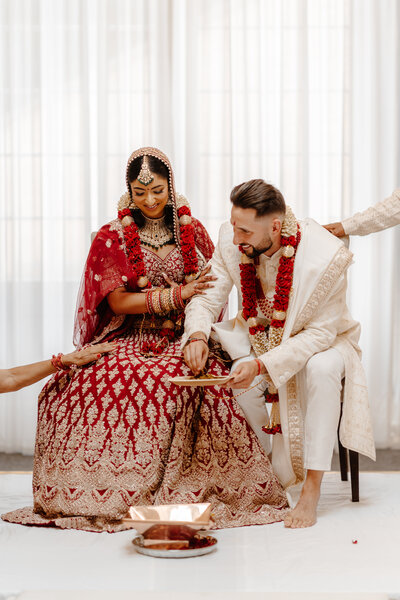 Hindu Fusion Wedding Ceremony at Rushton Hall  Bride in Red Lehenga by Frontier Raas