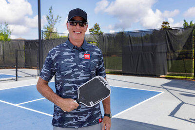 Mark Sullivan holding a paddle while on a Pickleball court – Life and Health Coach at LifeNBalance Coaching27