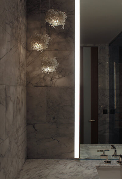 Detail shot of guest bathroom with floor to ceiling mirror and integrated lighting, designed by Sister Studio.