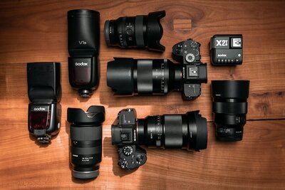 Sony full frame cameras and lenses sit on a wooden table