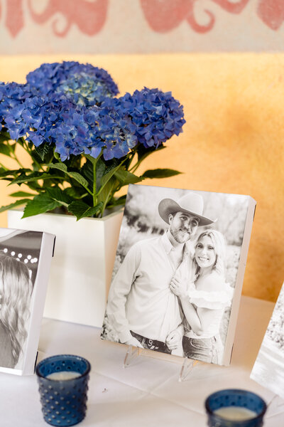 Blue hydrangea flowers and candles with black and white canvas.
