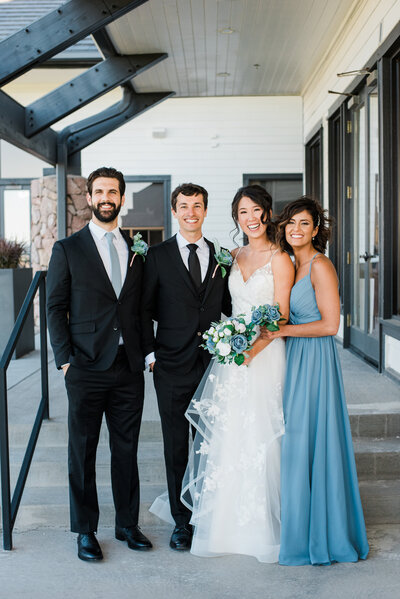 Colorado Micro wedding with bride and groom standing with their best man and maid of honor outside of their wedding venue photographed by denver wedding photographer