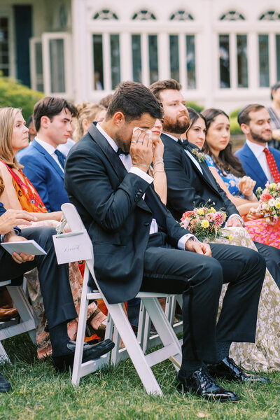 Best man wipes tears during ceremony at Glen Foerd Estate in Philadelphia, PA