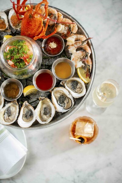 oysters and drink on white table