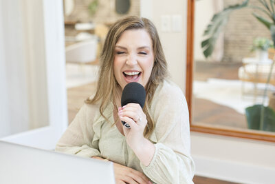 Erika holding a microphone as she's smiling