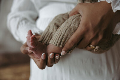 Close-up of a mother holding her newborn baby during a tender moment