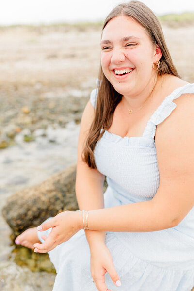 Young woman laughing at the beach