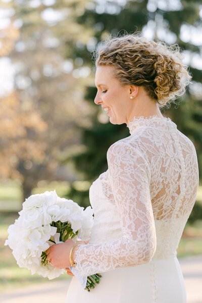 Bride wearing a lace bolero on her wedding day on the campus of the University of Notre Dame