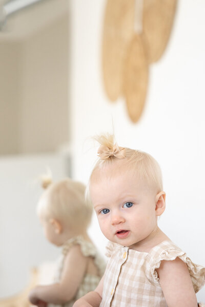 blue eyed one year old girl looks to camera at her Indianapolis photography session