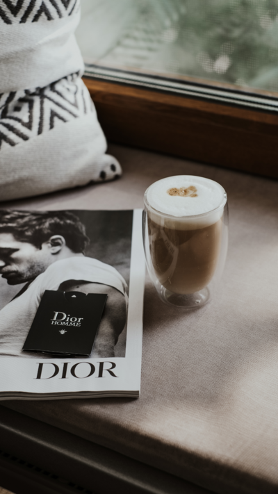 Coffee and Dior magazine representing inspiration and intentional design behind The Agency's brand vision