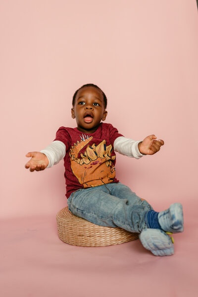 Smiling young boy posing for a playful and modern preschool portrait in the Twin Cities.