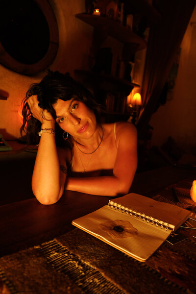 Tristan Thibodeau bathed in amber light, embracing the wild feminine.