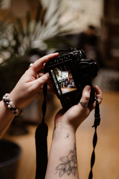 arms holding up a camera that is taking a photo