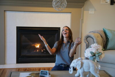 Shari Casanova Home Staging Mentor having fun throwing accessory in the air