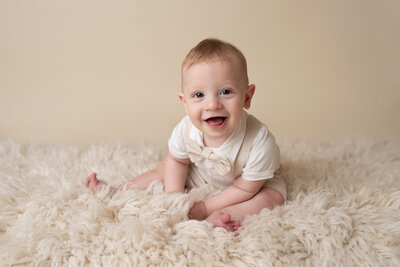smiling baby in a cream furry background captured in Houston