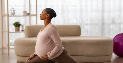 pregnant woman stretching and holding belly